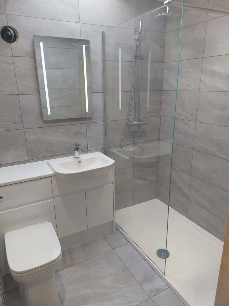 Fully tiled shower room with white gloss units